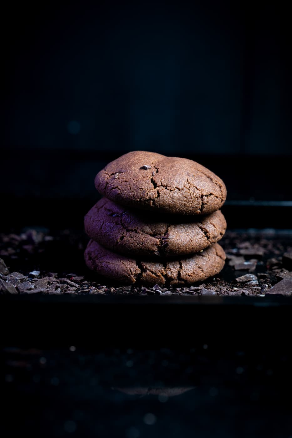Dark Chocolate Cookies stacked, dense and fudgy with a cracked top.
