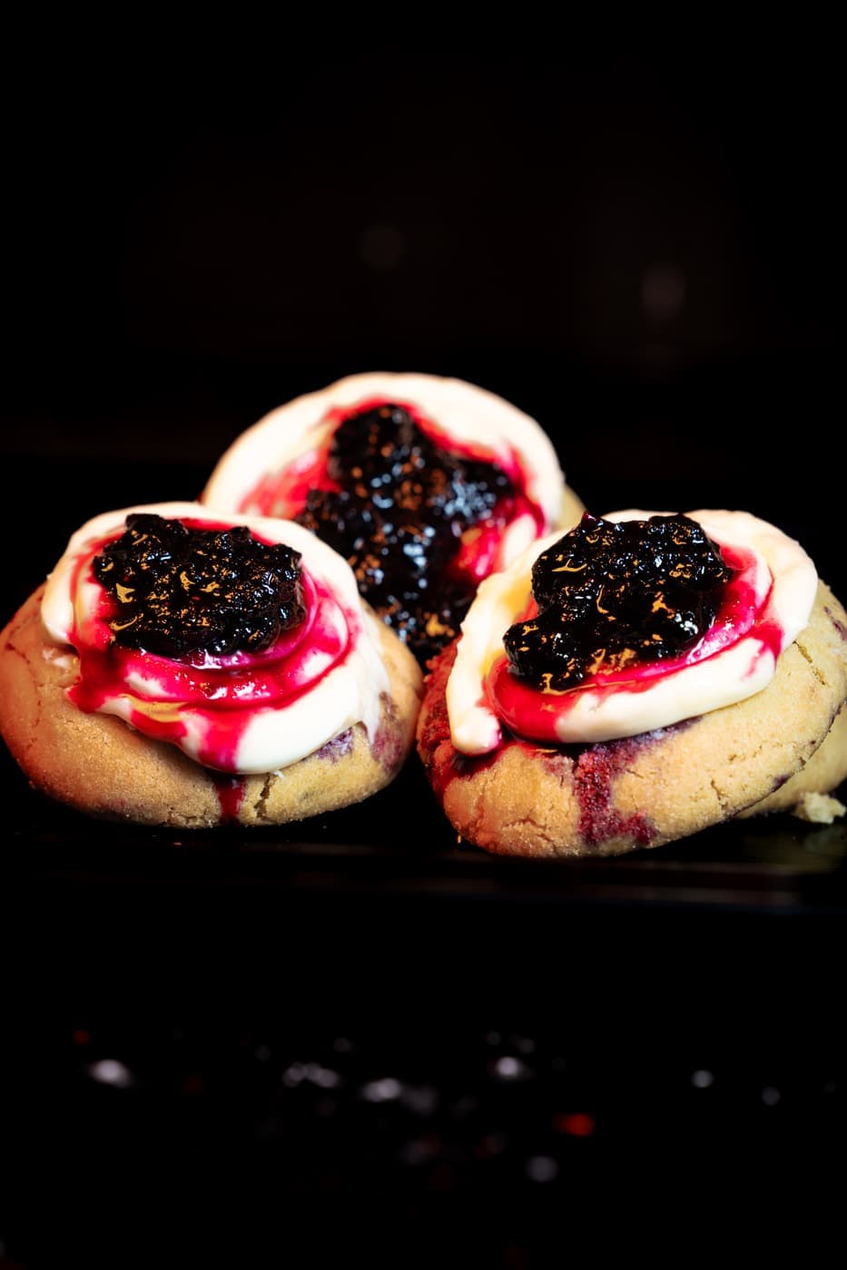A Lemonade Cookie: pale, soft-baked, finished with a sweet-tart glaze and a spoon of berry preserve.