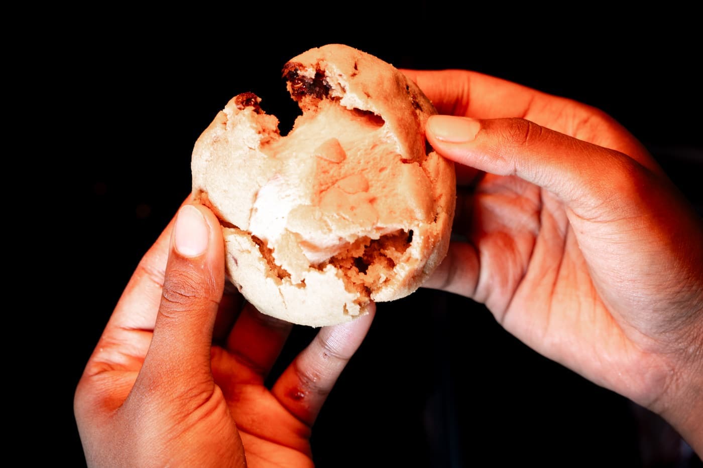 A S’more Cookie pulled apart, toasted marshmallow stretching between the halves.