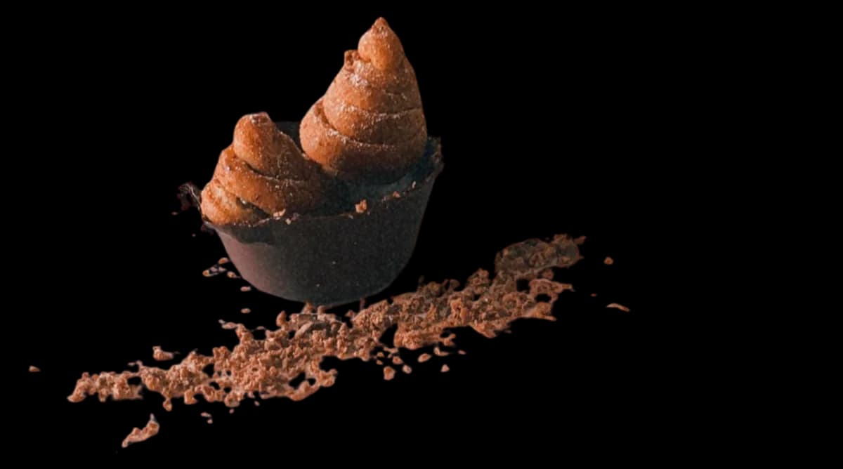 Piped chocolate cups in a crumb of cocoa biscuit.