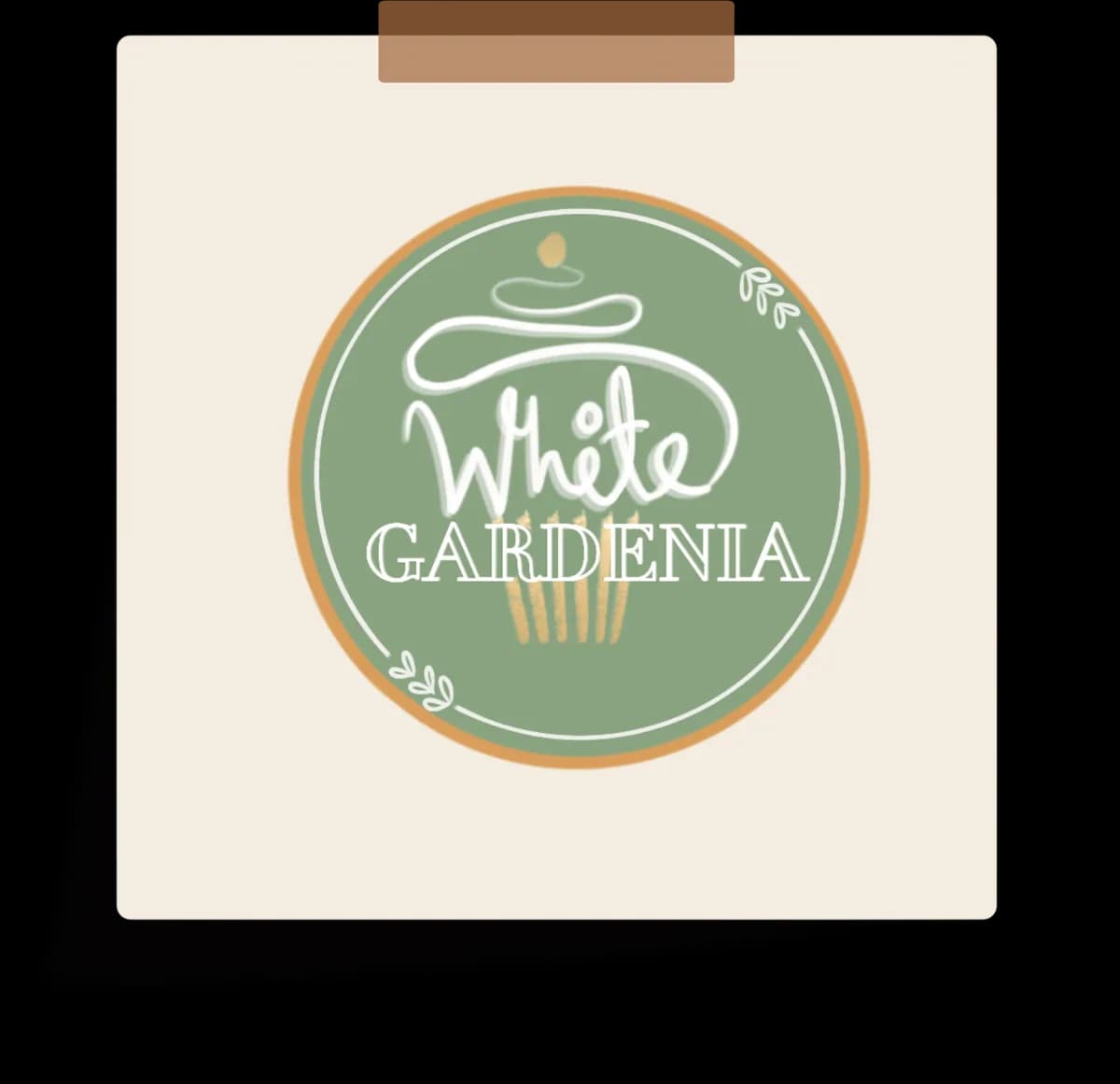 The White Gardenia logo, pinned to a card.